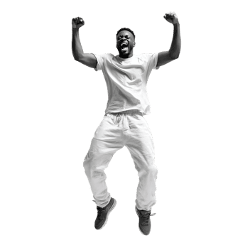 Joyful man leaps with excitement, arms raised in triumph.