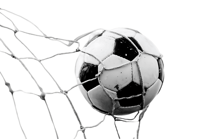 Close up of a soccer ball in the net. Black and white image.
