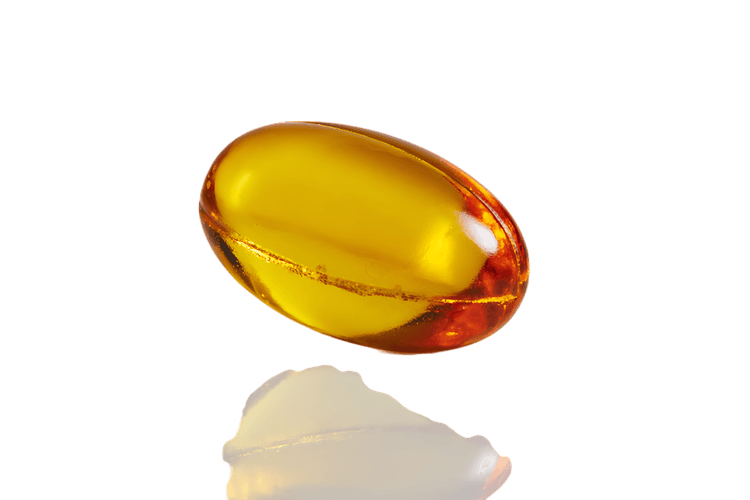 Close up of a single golden yellow capsule.