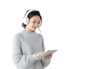Young woman using tablet and headphones.