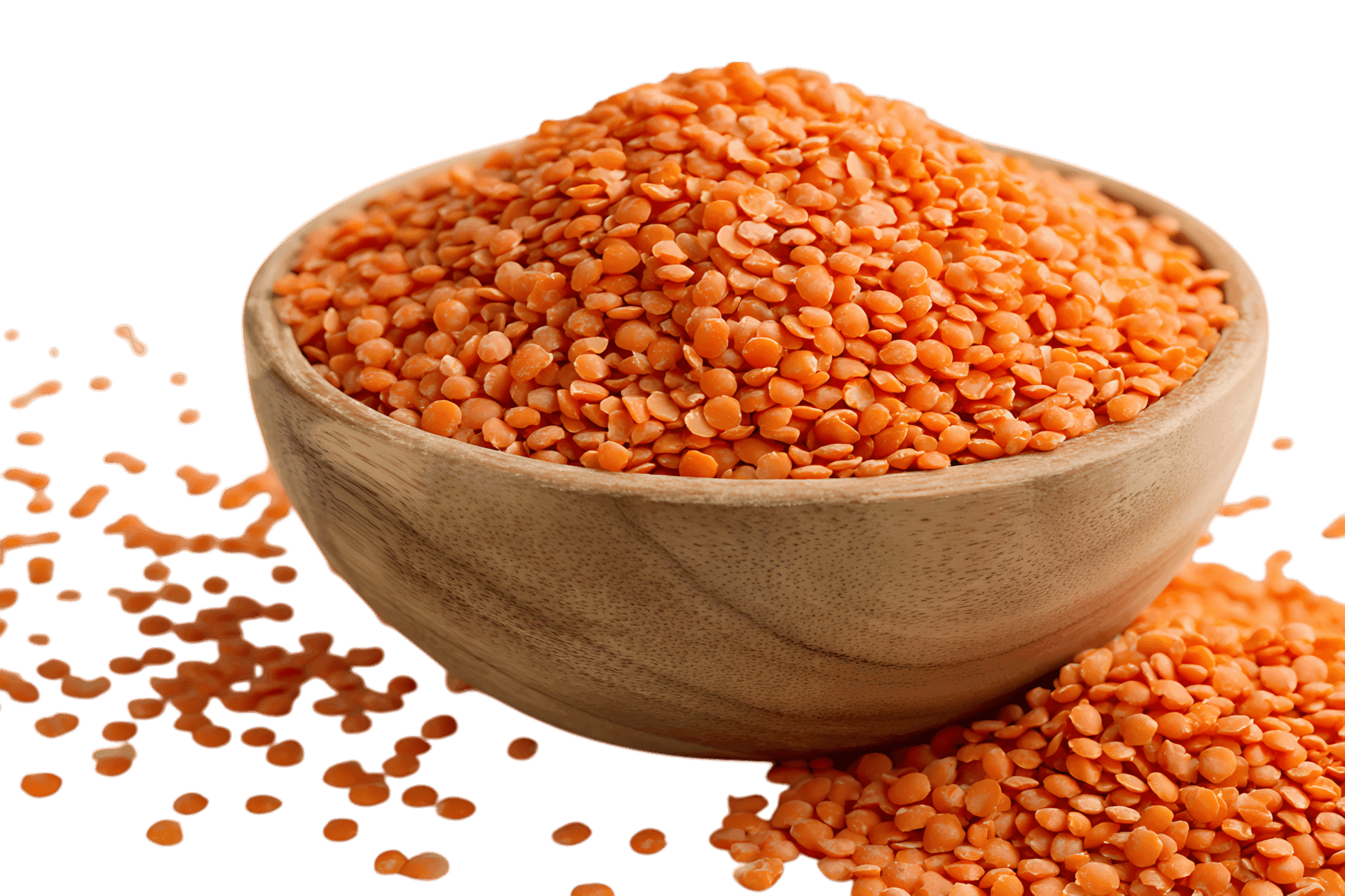 Red lentils in a wooden bowl, close up.