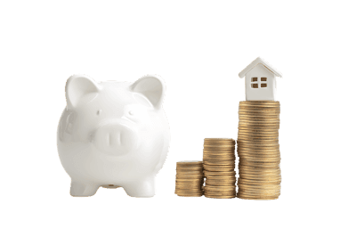 Piggy bank and coins stacking up to a house model