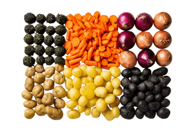 Flat lay of assorted vegetables,  carrots, potatoes, onions, and olives.