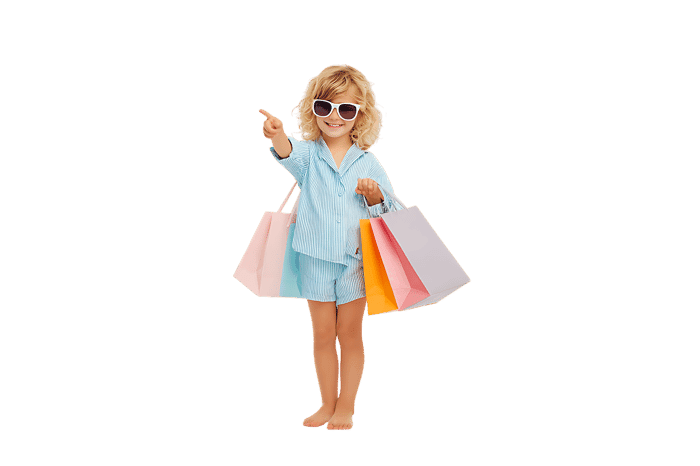 Happy child with shopping bags, pointing. Ideal for retail, shopping, and kids' fashion.