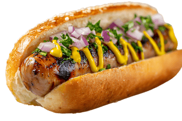 Grilled sausage in a bun with mustard and onions.