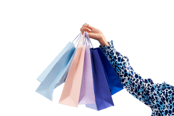 Woman's hand holding colorful shopping bags. Retail therapy, consumerism, shopping spree concept.
