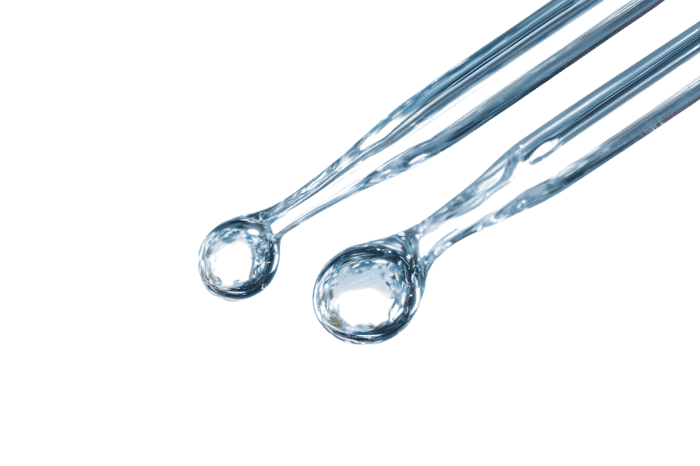 Close up of two clear plastic spoons.