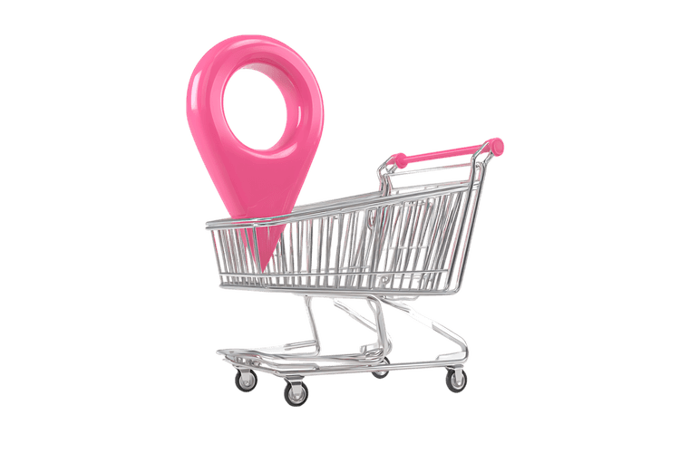 Pink location pin in shopping cart. Online shopping, delivery, location based services concept.
