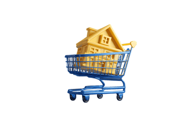 House shaped object in a shopping cart, signifying buying a home.