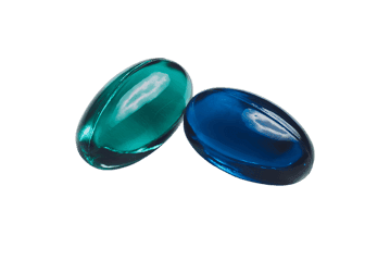 Close up of two vibrant capsules,  teal and blue.  Perfect for medicine, health, or wellness concepts.