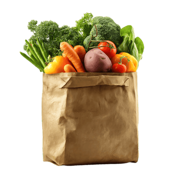 Fresh vegetables in a brown paper bag carrots