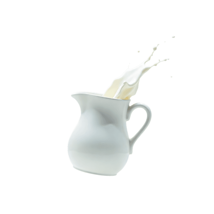 Milk splashing out of a white pitcher