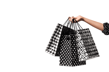 Hand holding shopping bags on black background
