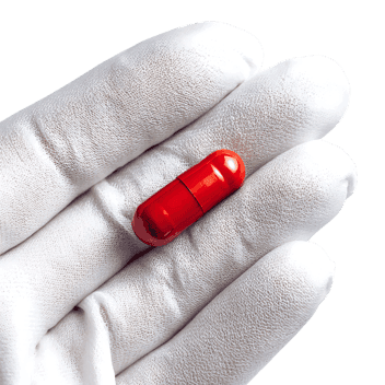 Red Capsule in a Hand