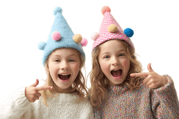 Two smiling girls in party hats