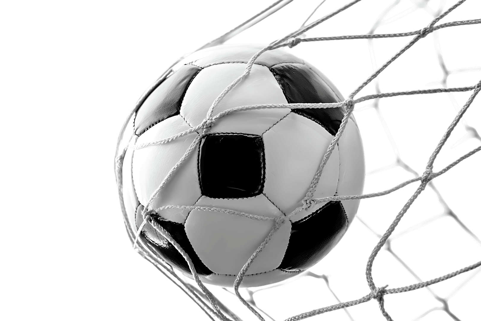 Soccer ball in goal net, black and white