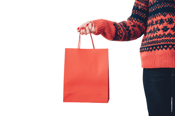 Person holding a coral shopping bag.