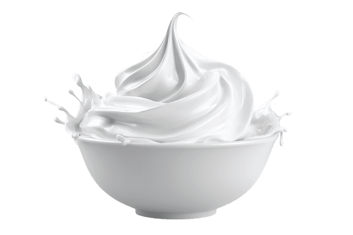 Fresh white whipped cream dollop in ceramic bowl, isolated on white background