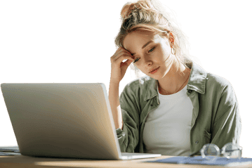 Tired woman working on laptop, feeling stressed.