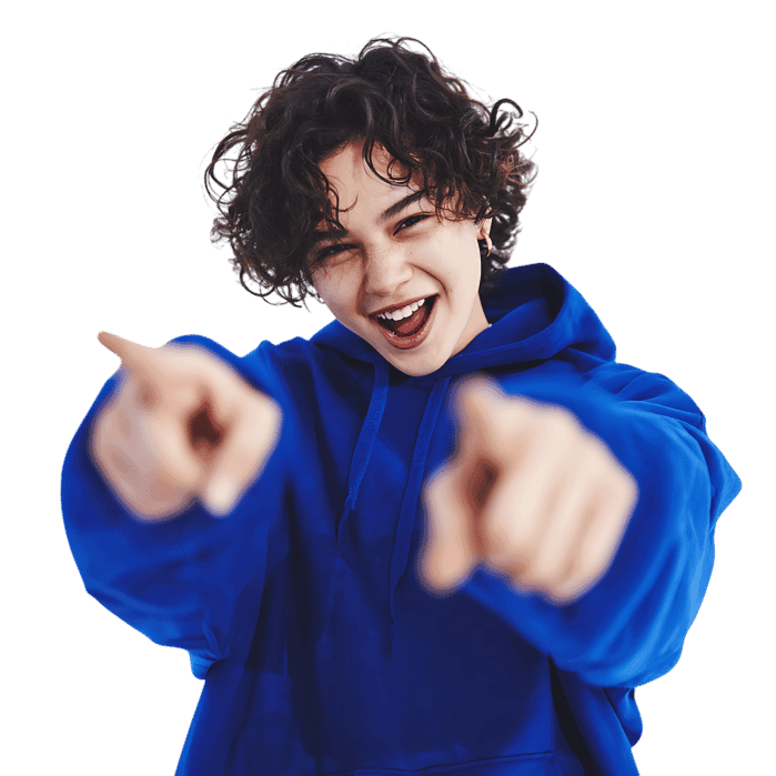 Happy, playful boy pointing towards camera, expressing excitement.