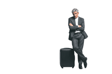 Businessman leaning against a suitcase, arms crossed.