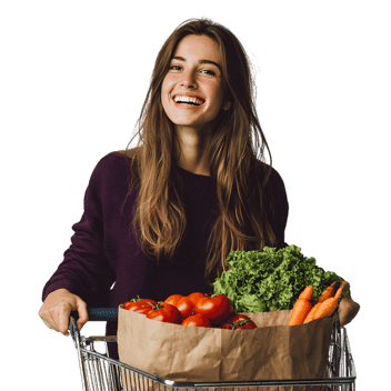 Smiling woman with shopping cart full of fresh produce. Healthy eating concept.