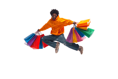 Joyful man leaps with shopping bags