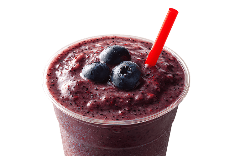 Delicious blueberry smoothie in a plastic cup with a red straw.