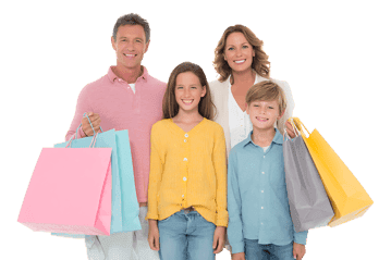 Happy family of four with shopping bags.
