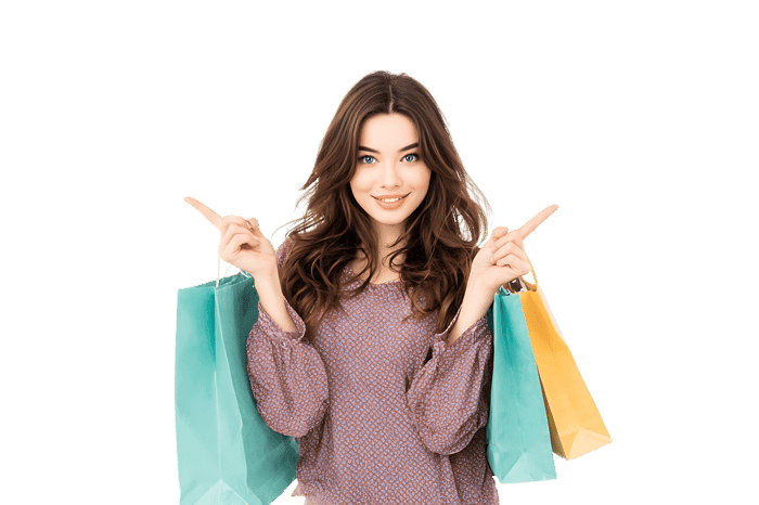 Happy woman with shopping bags pointing sideways