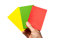 Hand holding a set of referee cards,  yellow, green, red. Sports concept.