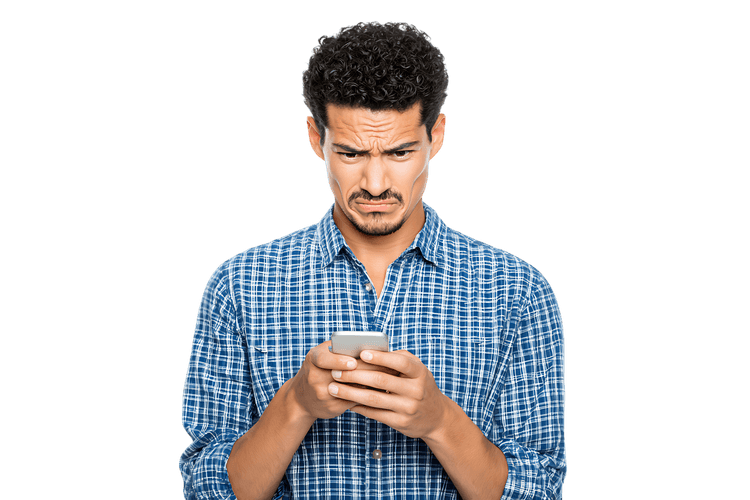 Man looking displeased at his cellphone screen.