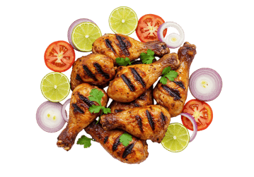 Grilled chicken legs with lime, tomato, and onion.