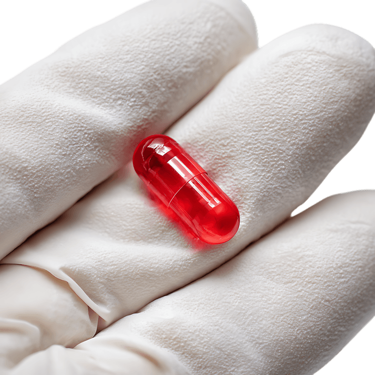 Red Capsule in Gloved Hand