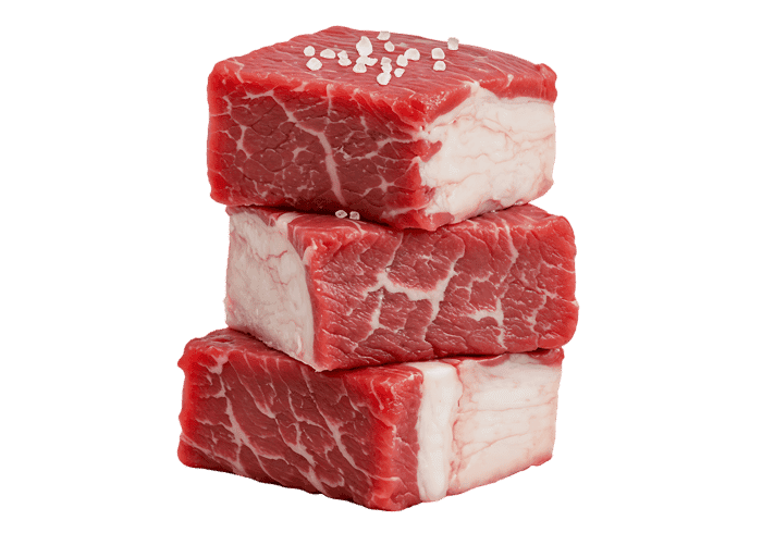 Stack of fresh beef cubes, seasoned with salt.