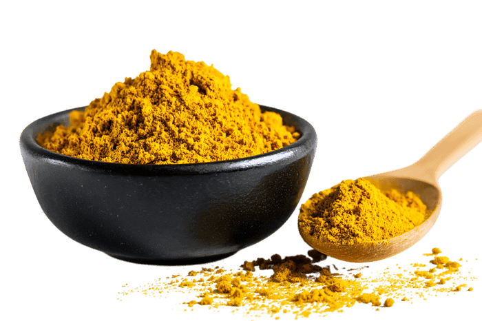 Golden turmeric spice in a black bowl and wooden spoon.