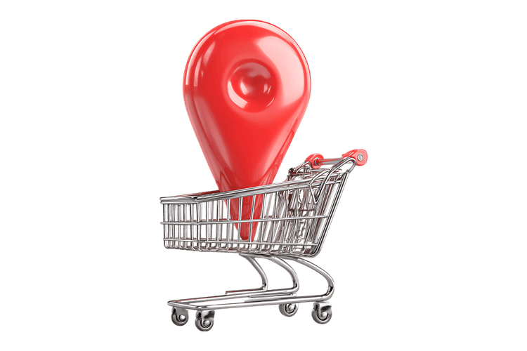 Red map pointer in shopping cart. Location based shopping concept.