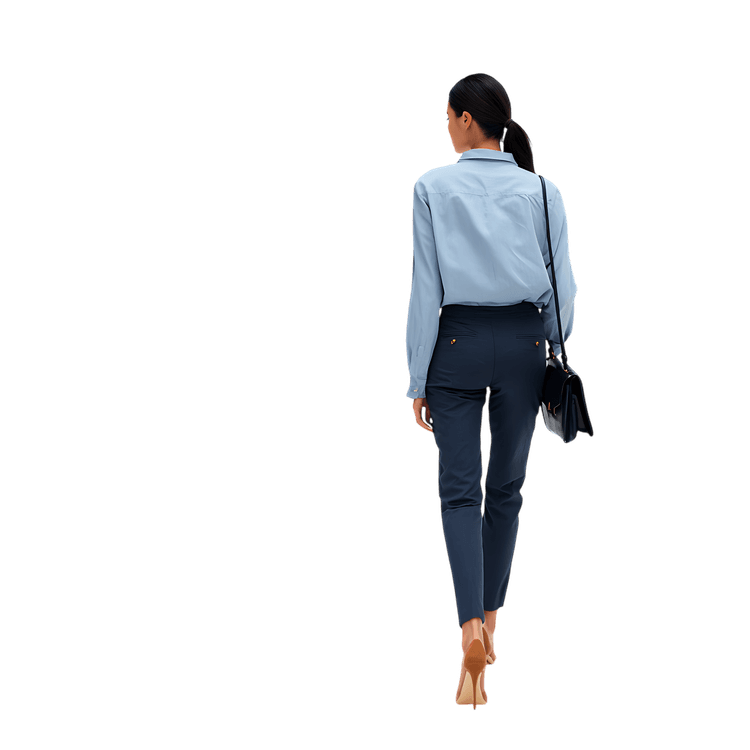 Woman in business attire walking, seen from behind. Conveys purpose, ambition.