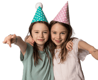 Two girls in party hats point at the camera.