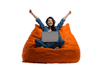 Joyful young woman celebrating success while working from home in a comfortable beanbag chair