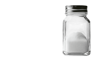 A clear, empty glass jar on a black background.